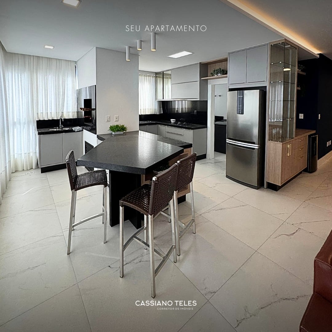 Sala de estar integrada à cozinha no apartamento à venda Itapema Carmel Residence.